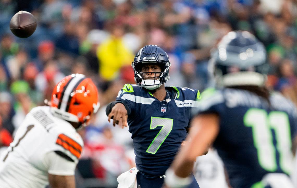 Seahawks quarterback Geno Smith (7) completes a pass to wide receiver Jaxon Smith-Njigba (11) during the first quarter of an NFL preseason game against the Cleveland Browns at Lumen Field in Seattle Saturday, Aug. 24, 2024.