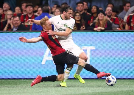 Dec 8, 2018; Atlanta, GA, USA; Atlanta United defender Jeff Larentowicz (18) battles for the ball with Portland Timbers forward Lucas Melano (26) in the second half in the 2018 MLS Cup championship game at Mercedes-Benz Stadium. Mark J. Rebilas-USA TODAY Sports