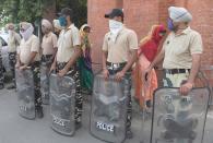 Punjab Police personnel stand guard during Bharat Bandh, a nationwide farmers' strike, following the recent passing of agriculture bills in the Lok Sabha (lower house), in Amritsar on September 25, 2020. (Photo by NARINDER NANU/AFP via Getty Images)