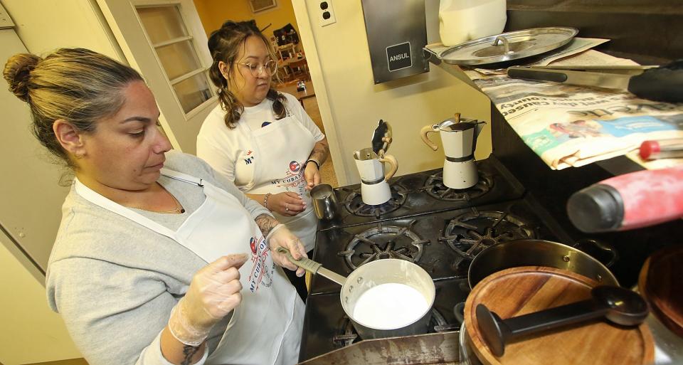 Jamie Gonzalez, left, and Nancy Cobos prepare coffee in the kitchen of the newly opened My Cuban Corner on Catawba Street in Belmont Monday morning, March 6, 2023.