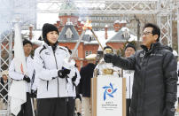 In this Feb. 6, 2017 photo, Mai Asada, front left, elder sister of Japanese figure skater Mao Asada, and Sapporo Mayor Katsuhiro Akimoto attend a departing ceremony of a torch relay for 2017 Asian Winter Games in Sapporo, northern Japan. With the Winter Olympics just a year away, the Asian Winter Games will be the ideal stage for the continent’s leading winter athletes to fine tune for Pyeongchang 2018. The eighth Asian Winter Games will open in Sapporo on Sunday, Feb. 19 and run through Feb. 26, with more than 2,000 athletes from 31 countries competing in five sports, 11 disciplines and 64 events. (Masanori Takei/Kyodo News)