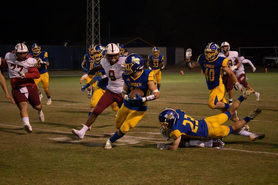Dax Weber runs approximately 90 yards that resulted in a turn back on Linden’s touchdown and interception at Linden High school in Linden, CA on Nov. 3, 2023.