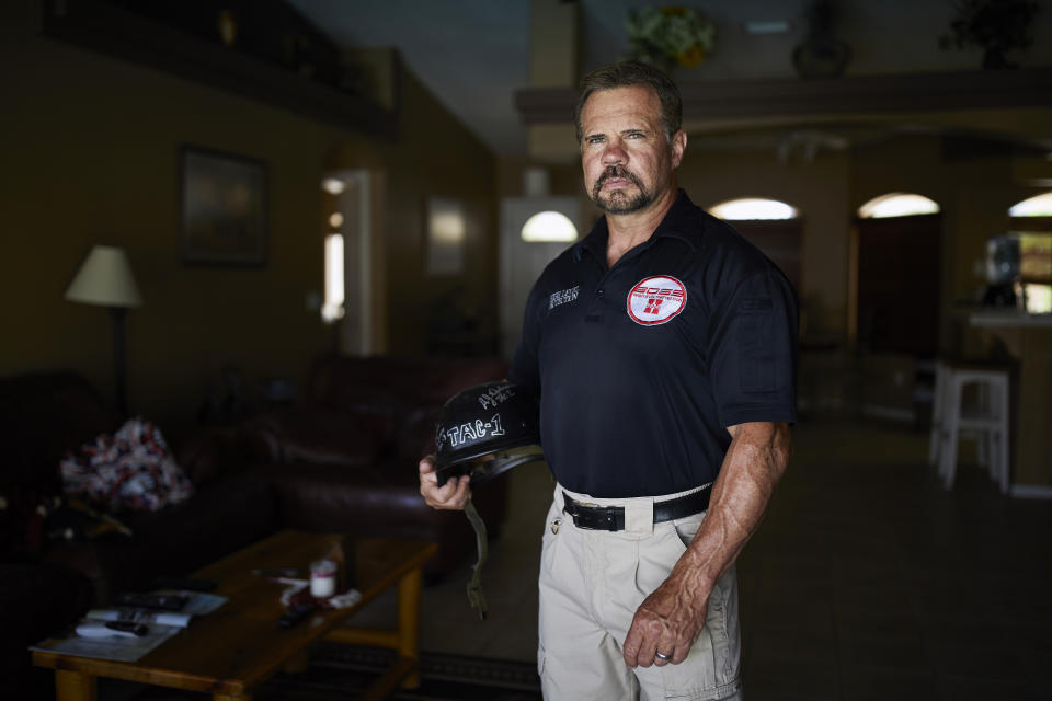 In this April 9, 2019, photo, Grant Whitus poses for a portrait at his home in Lake Havasu City, Ariz. Whitus' marriage fell apart a year after he led his SWAT team into Columbine High School's library, where he was the first to find the dead children's bodies. (AP Photo/John Locher)
