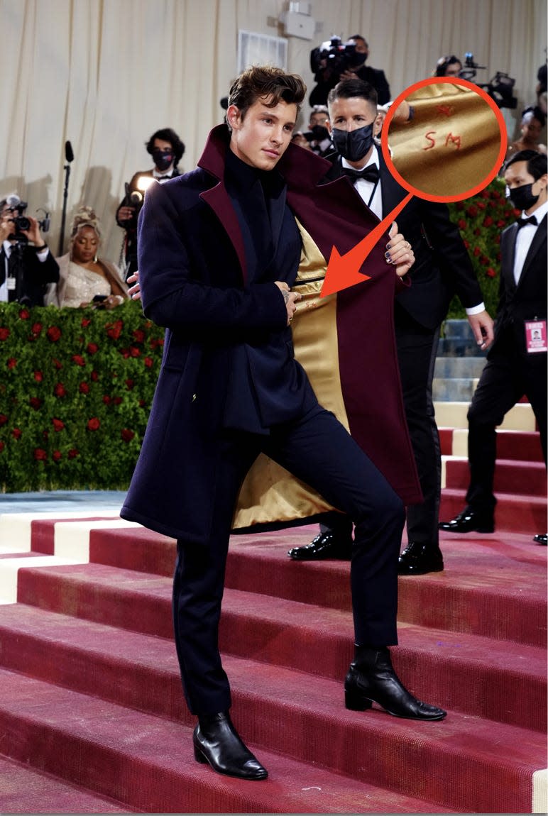 Shawn Mendes in blue and red coat with initials at the met gala