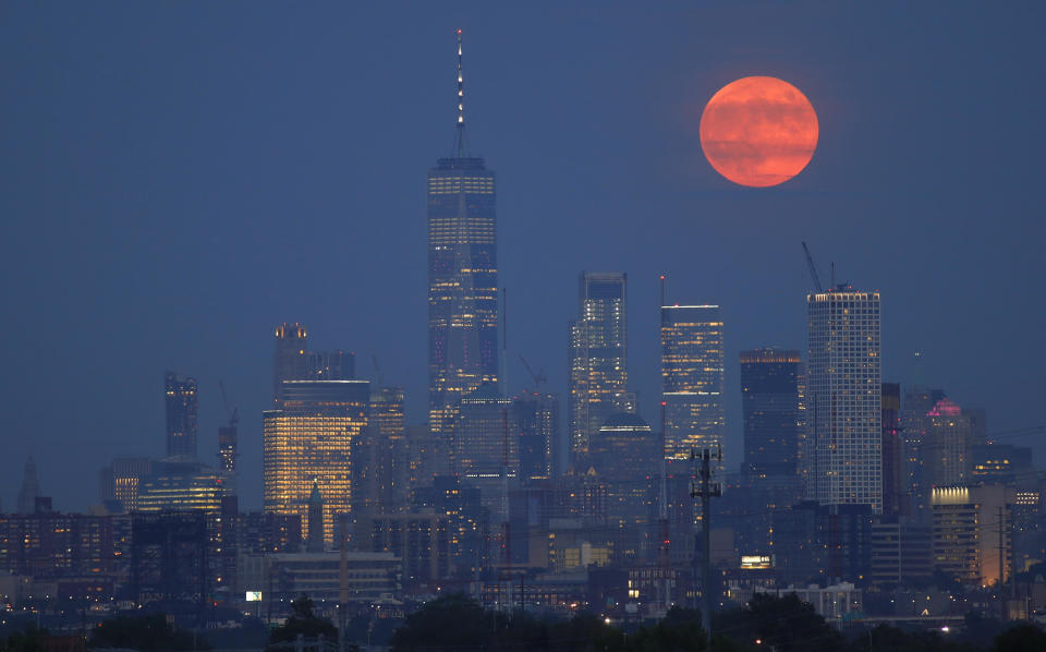 The full buck moon rises above the skyline of lower Manhattan and One World Trade Center in New York City on July 16, 2019, as seen from Kearney, New Jersey. / Credit: Gary Hershorn / Getty Images