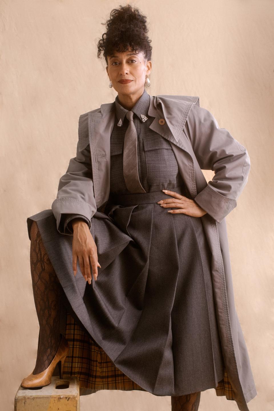 <cite class="credit">Gucci trench coat. Stella McCartney men's top. Gucci tie. Gucci skirt. Falke tights. Gucci shoes. Mateo pearl earrings.</cite>