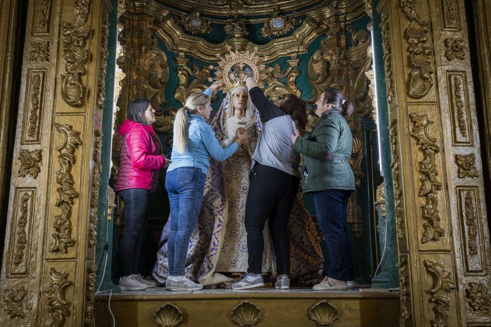 Members of the "Vera Cruz" Catholic brotherhood place back the "Virgen de los Dolores" after a Holy Week procession in the southern town of Quesada, Spain, Saturday, March 30, 2024. (AP Photo/Bernat Armangue)