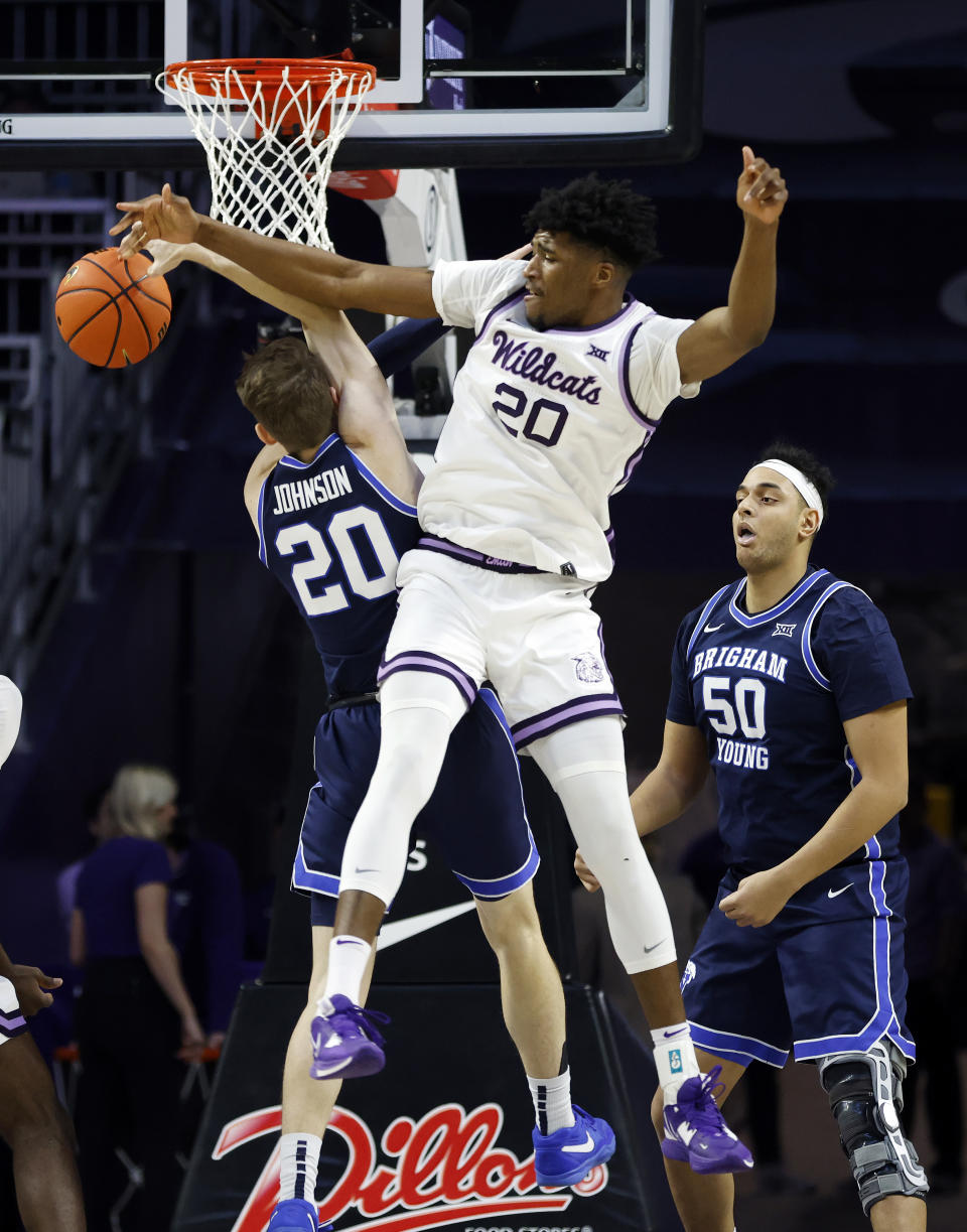 Kansas State forward Jerrell Colbert (20) knocks a rebound away from BYU guard Spencer Johnson (20) during the first half of an NCAA college basketball game, Saturday, Feb. 24, 2024, in Manhattan, Kan. (AP Photo/Colin E. Braley)