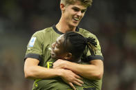 AC Milan's Rafael Leao, bottom, celebrates with bis teammate Charles De Ketelaere after scoring his side's opening goal during a Serie A soccer match between AC Milan and Bologna at the San Siro stadium in Milan, Italy, Saturday, Aug. 27, 2022. (AP Photo/Luca Bruno)