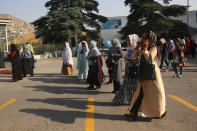 Delegates wait for transportation on the first day of the Afghan Loya Jirga meeting in Kabul, Afghanistan, Friday, Aug. 7, 2020. The traditional council opened Friday in the Afghan capital to decide the release of a final 400 Taliban - the final hurdle to the start of negotiations between Kabul’s leadership and the Taliban in keeping with a peace deal the United States signed with the insurgent movement in February. (AP Photo/Rahmat Gul)