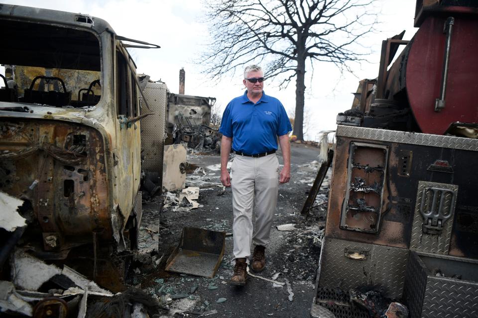 Patrick Vaughn, co-owner of the Von Bryan Estate, walks through three burned firefighting engines which fought the Hatcher Mountain/Indigo Lane wildfire at the property last week on Hatcher Mountain Road in Wears Valley, Tenn. Vaughn said the first responders narrowly escaped with their lives. Piles or rubble and the melted fire engines are all that remain at the former 10,000-square-foot family run bed and breakfast. The Hatcher Mountain/Indigo Lane fire burned roughly 2,500 acres and affected 219 structures in the Great Smoky Mountains community. 