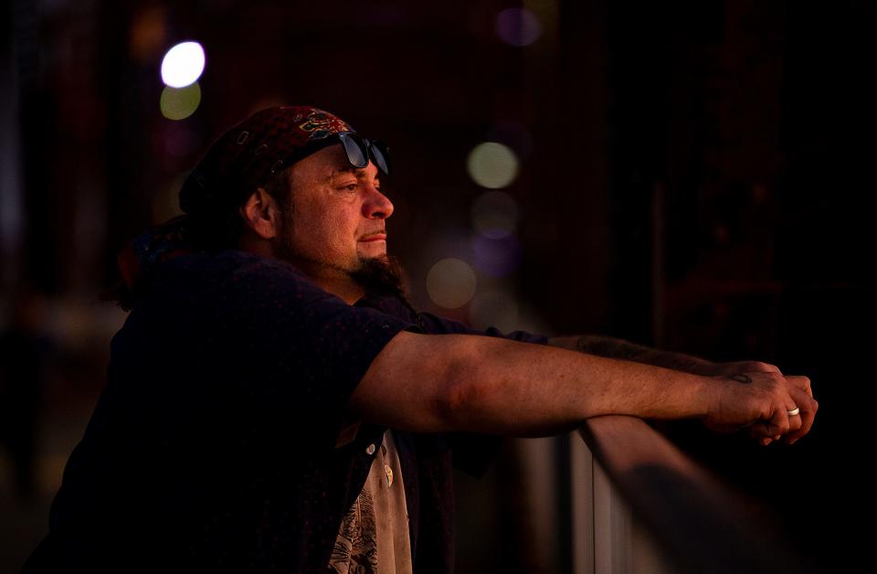 Fortune teller Steven Lafferty watches the sun set over the Ohio River from the Big Four Bridge in Louisville, Ky. Lafferty engages those who stop by with his experience as a mystic and his life as a fortune teller. Nov. 10, 2022