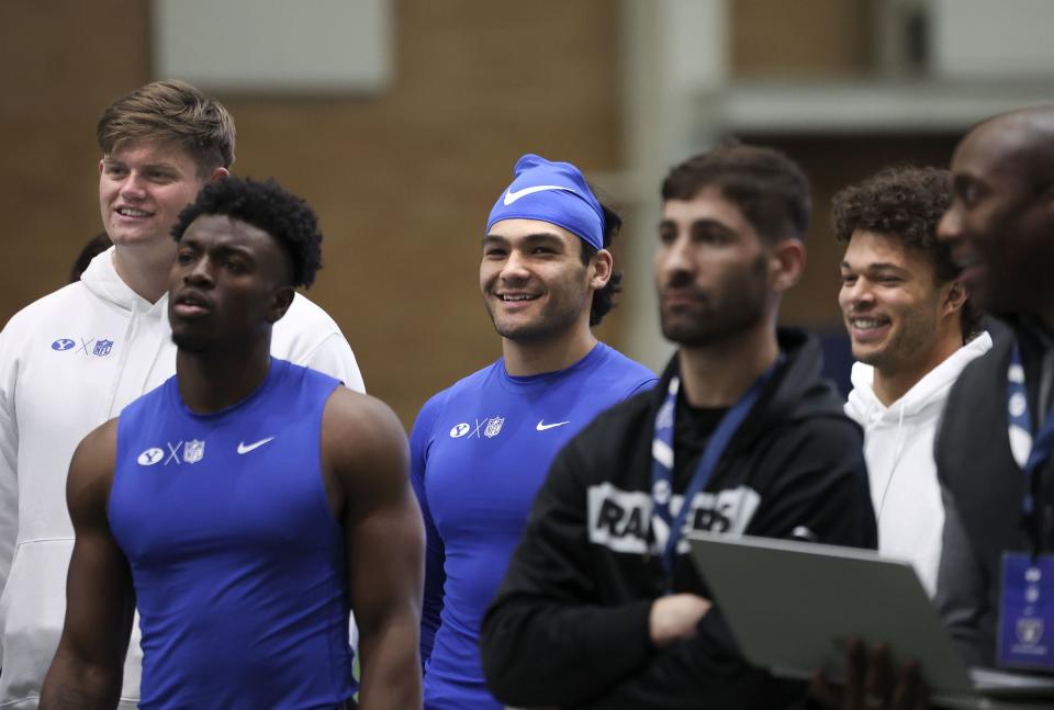 BYU’s Blake Freeland, left, D’Angelo Mandell, Puka Nacua, an NFL scout, Jaren Hall and another scout look on