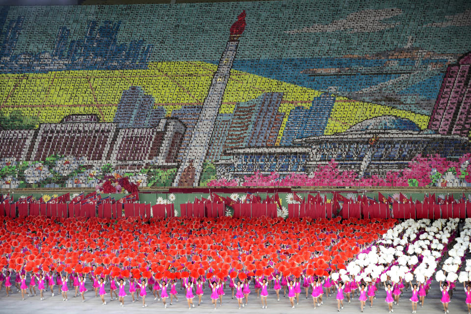 In this Sept. 11, 2019, photo, North Korean dancers perform as mosaic of The Tower of The Juche Idea is formed during a mass games performance titled: "The Land of the People" at May Day Stadium in Pyongyang, North Korea. It's just a single word, but it's hard to miss in North Korea: Splashed across countless propaganda signs, seeded through dozens of state media reports, at the beating heart of emotional pop songs and on the lips of the earnest guides who show off the grand monuments built in its honor. The word is Juche, and while it's technically a political ideology, in its difficulty for many outsiders to grasp, its ability to inspire devotion among North Koreans, and its ubiquity as a symbol of state power, it can seem more like a religion. (AP Photo/Dita Alangkara)