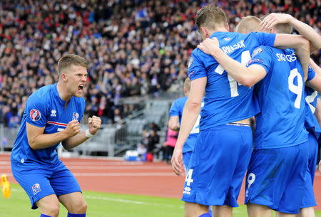 Iceland's Kolbeinn Sigthorsson (number 9) celebrates with team mates and Johann Gudmundsson (L) after scoring against Czech Republic during their Euro 2016 qualifying soccer match in Reykjavik, Iceland, June 12, 2015. REUTERS/Sigtryggur Johannsson