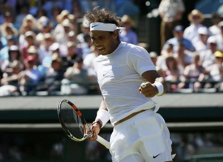 Rafael Nadal of Spain celebrates a break of serve during his match against Thomaz Bellucci of Brazil at the Wimbledon Tennis Championships in London, June 30, 2015. REUTERS/Stefan Wermuth