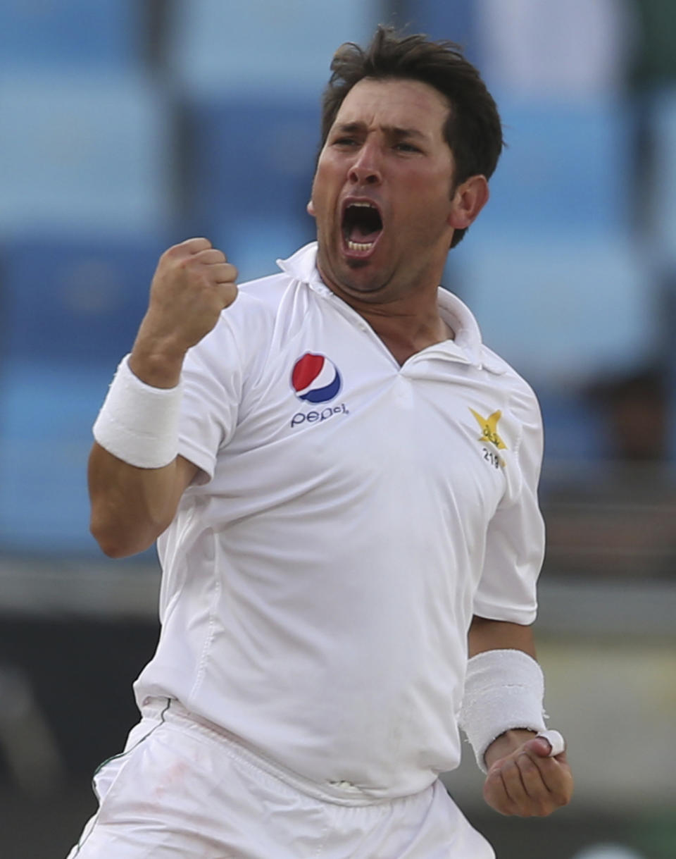 Pakistan's bowler Yasir Shah celebrates after dismissal of Usman Khawaja during their test match in Dubai, United Arab Emirates, Thursday, Oct. 11, 2018. (AP Photo/Kamran Jebreili)