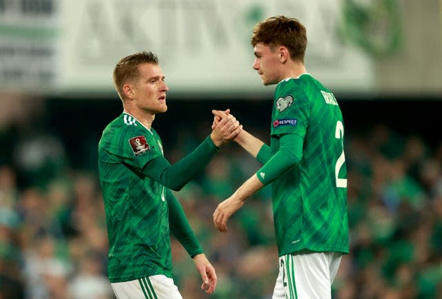 Steven Davis (left) and Conor Bradley shake hands