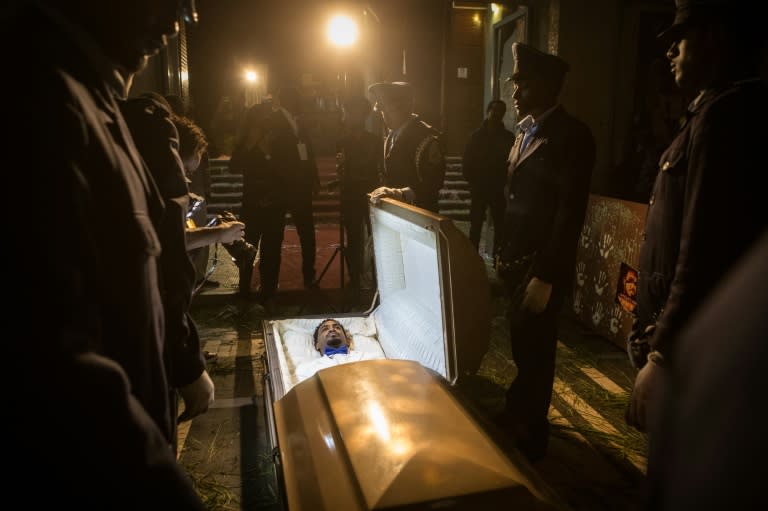 Six white-gloved pallbearers carried the coffin holding Ethiopian migrant Zekarias Mesfin who said he aimed to show how close to death he came on his perilous journey