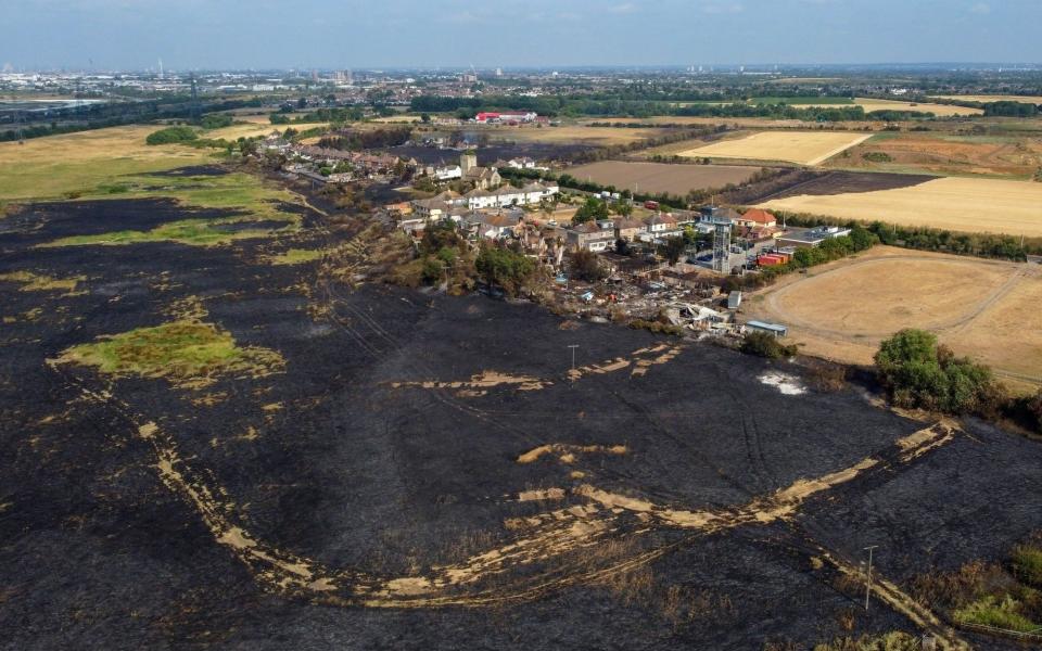 Burnt fields and houses destroyed following a major fire in Wennington - Chris Ratcliffe/Bloomberg