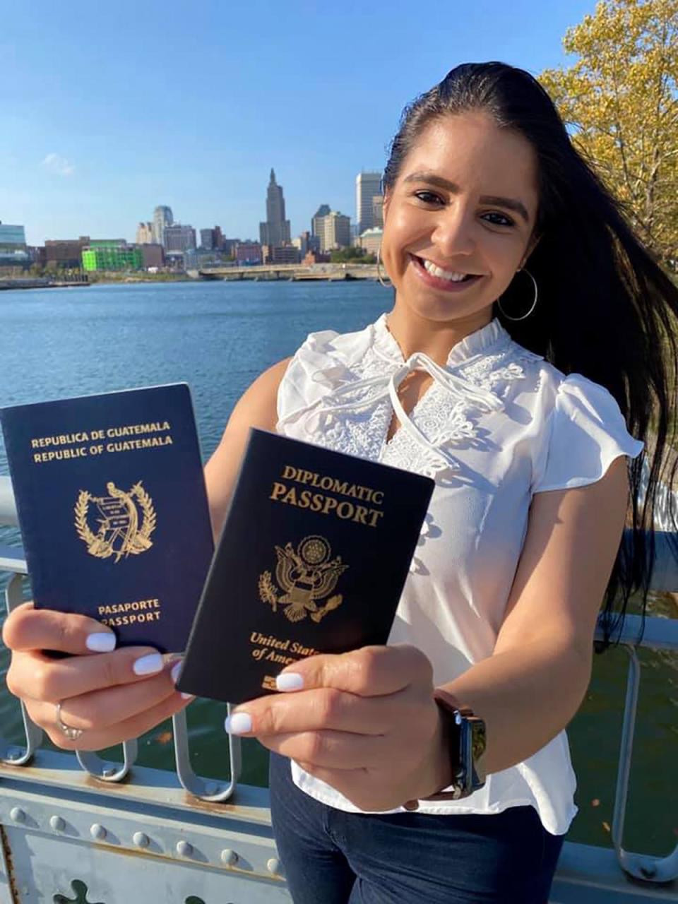 Marta Aparicio, who overcame poverty in Guatemala and Providence to become a U.S. diplomat, shows her old passport, where her journey began, and her new State Department-issued diplomatic passport.