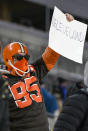 CORRECTS TIME OF PHOTO TO LATE SUNDAY, JAN. 10 INSTEAD OF EARLY MONDAY, JAN. 11 - A Cleveland Browns fan holds a sign after an NFL wild-card playoff football game between the Pittsburgh Steelers and the Cleveland Browns in Pittsburgh, late Sunday, Jan. 10, 2021. The Browns won 48-37. (AP Photo/Don Wright)