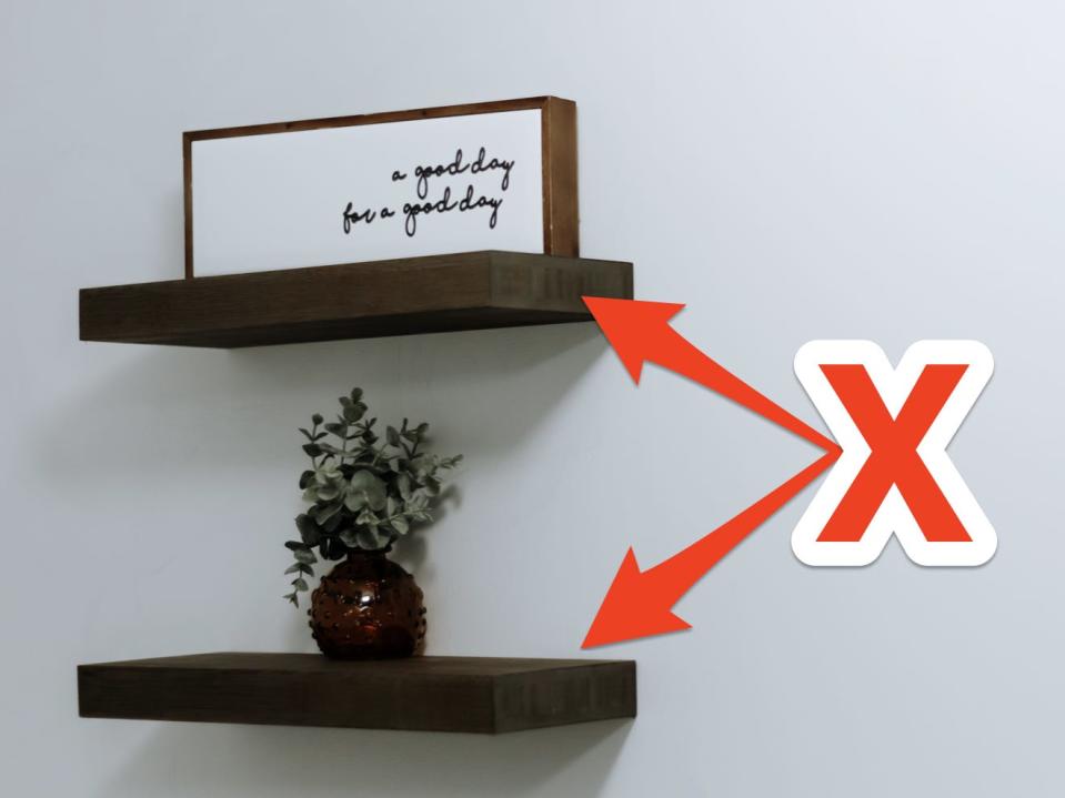 Floating shelves holding a sign and a plant with a red X and arrows pointing to the shelves