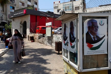 Pictures depicting Palestinian President Mahmoud Abbas are seen in Ramallah, in the Israeli-occupied West Bank