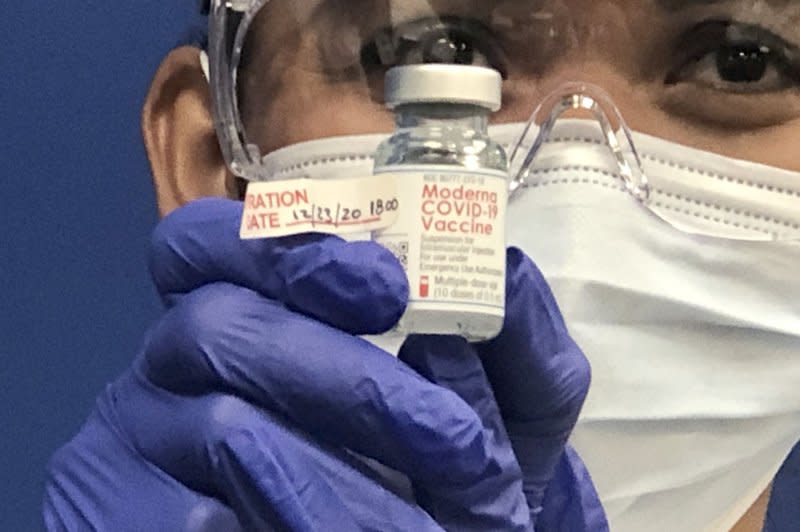 FILE: Leonida Lipshy, RN in the COVID unit at the Broward Health Medical Center, Imperial Point, Fort Lauderdale, Florida, displays a bottle of the Moderna COVID-19 vaccine on December 23, 2020. Broward Health was one of the first facilities that started vaccinating primary healthcare workers with the Pfizer-BioNTech COVID-19 vaccine. Photo by Gary I Rothstein/UPI