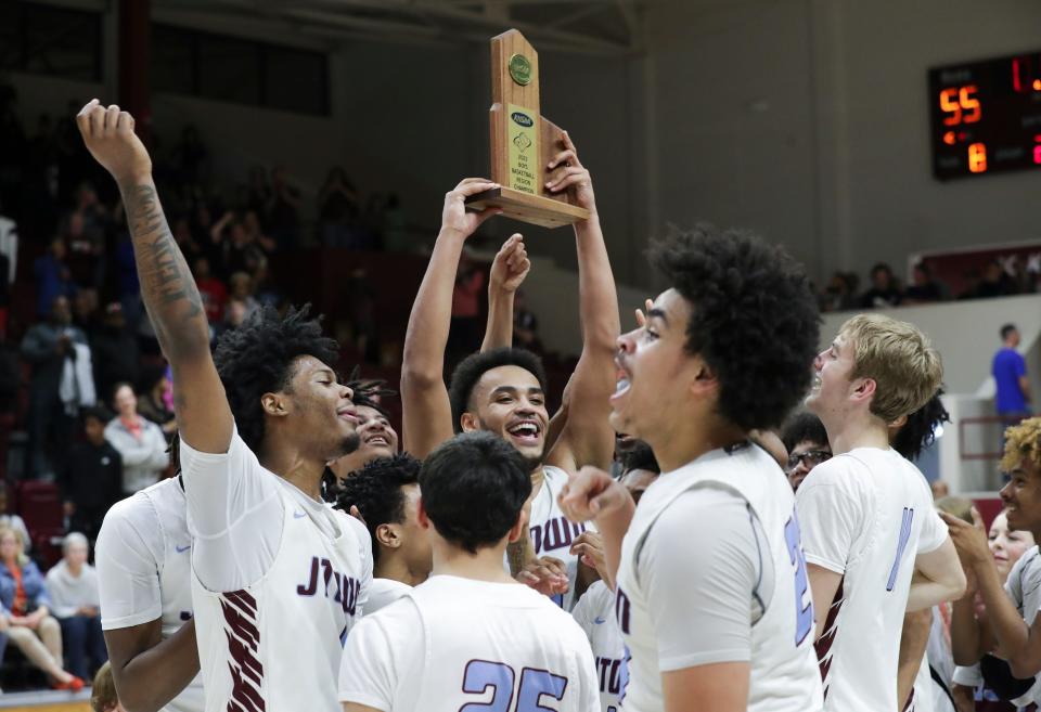 J-Town hoisted the 6th Region Championship trophy after they defeated Desales 55-54 during the championship of the 6th Region tournament at Bellarmine Knights Hall in Louisville, Ky. on Mar. 6, 2023.