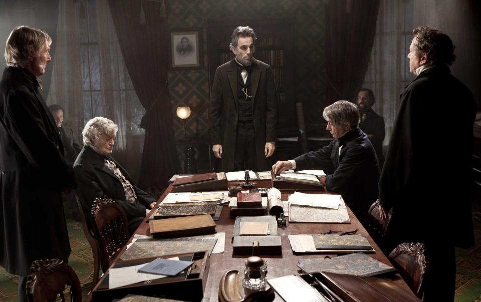 FILE - This undated publicity photo released by DreamWorks and Twentieth Century Fox shows, Daniel Day-Lewis, center rear, as Abraham Lincoln, in a scene from the film, "Lincoln." Day-Lewis, who plays the 16th president in Steven Spielberg's epic film biography “Lincoln,” settled on a higher, softer voice, saying it's more true to descriptions of how the man actually spoke. “Lincoln” opened in limited release Nov. 9, 2012, and expands nationwide Friday, Nov. 16. (AP Photo/DreamWorks, Twentieth Century Fox, David James, File)