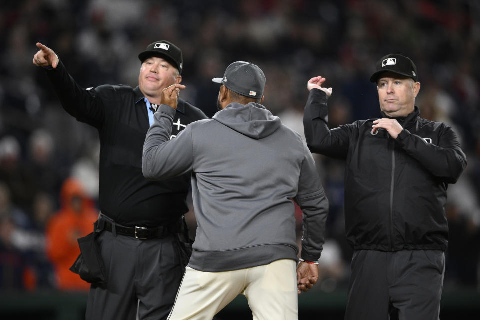 Washington Nationals manager Dave Martinez, center, is ejected by umpire Cory Blaser, left, and third base umpire umpire Todd Tichenor, right, at the end of the eighth inning of a baseball game against the Houston Astros, Friday, April 19, 2024, in Washington. (AP Photo/Nick Wass)