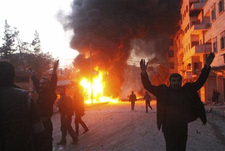 Men react near a site hit by what activists say are barrel bombs dropped by government forces on al-Katerji district in Aleppo, January 21, 2014. REUTERS/Hosam Katan