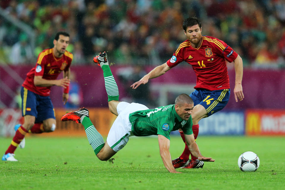 GDANSK, POLAND - JUNE 14: Jonathan Walters of Republic of Ireland clashes with Xabi Alonso of Spain during the UEFA EURO 2012 group C match between Spain and Ireland at The Municipal Stadium on June 14, 2012 in Gdansk, Poland. (Photo by Alex Grimm/Getty Images)