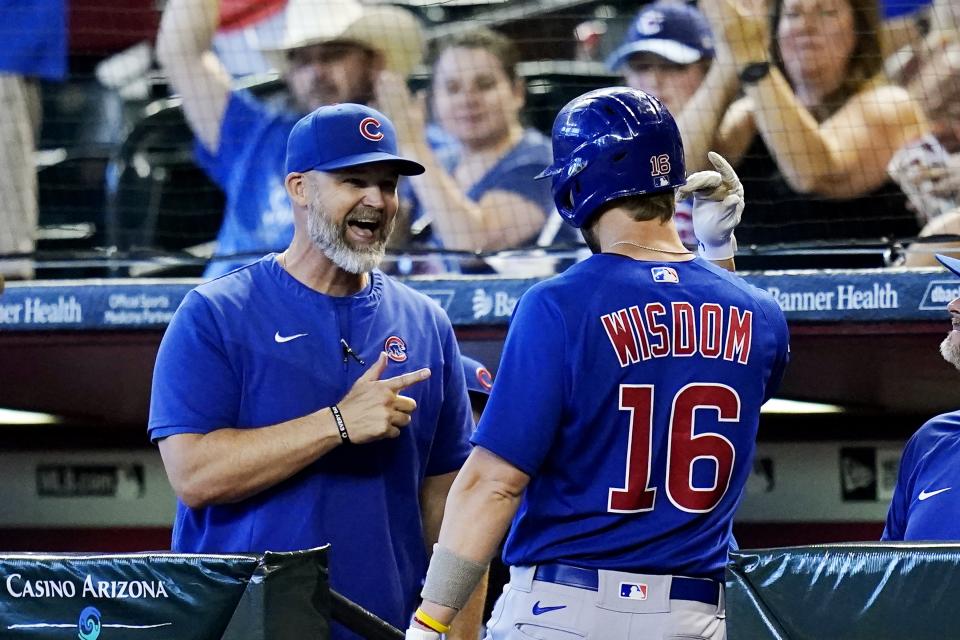 Chicago Cubs' Patrick Wisdom (16) celebrates his home run against the Arizona Diamondbacks with manager David Ross, left, during the second inning of a baseball game Sunday, May 15, 2022, in Phoenix. (AP Photo/Ross D. Franklin)