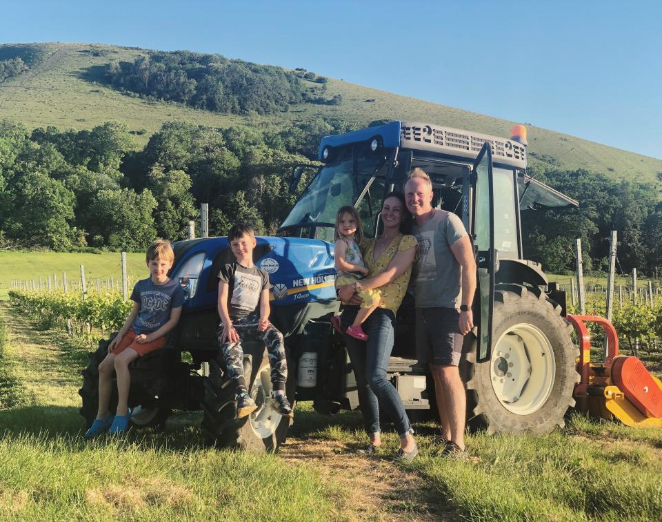 Charlotte and Ivan Weightman at their Wolstonbury vineyard in the South Downs, with their three children (Wolstonbury)