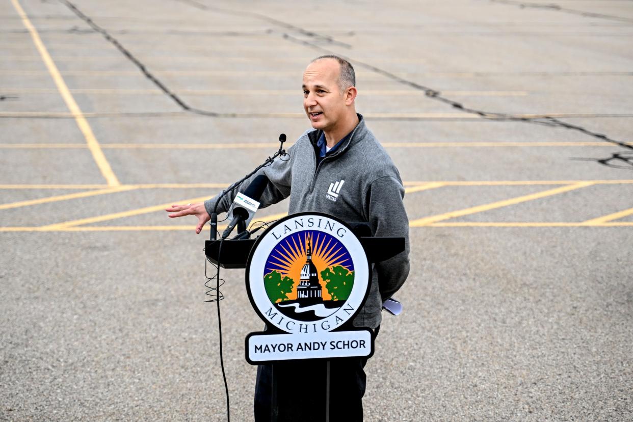 Mayor Andy Schor speaks during a press conference at the proposed site of city hall in a parking lot on Grand Avenue across from CATA's downtown transportation center on Thursday, May 9, 2024, in Lansing.