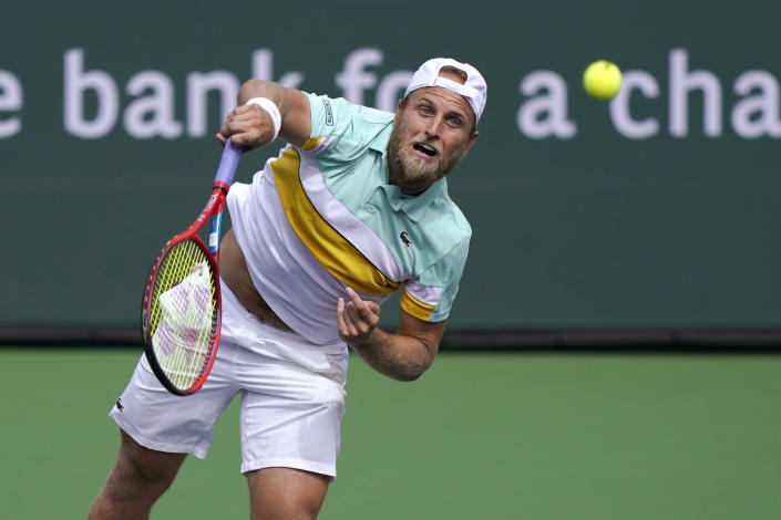 Denis Kudla, of the United States, serves to Alejandro Tabilo, of Chile, at the BNP Paribas Open tennis tournament Friday, Oct. 8, 2021, in Indian Wells, Calif. (AP Photo/Mark J. Terrill)