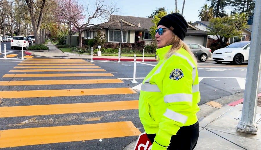 A crossing guard works outside Castlemont Elementary School on March 28, 2024.