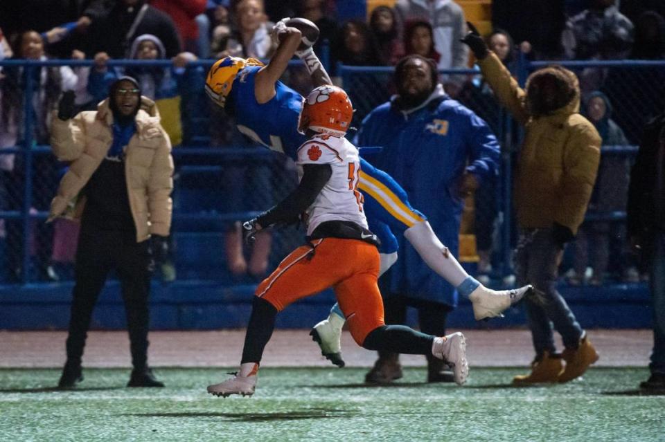 Grant Pacers receiver Kingston Lopa (2) makes the catch over San Jacinto Tigers cornerback Hajani Washington (14) to score a touchdown during the second half of the 2022 CIF State Football Division III-AA Championship on Saturday, Dec. 10, 2022, at Grant High School in Sacramento. The Pacers won 36-34.