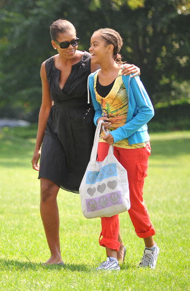 First lady Michelle Obama walks with her daughter, Malia Obama as they walk across the South Lawn upon their return to the White House September 6, 2009 in Washington, DC. The first family was vacationing at Camp David. (Photo by Ron Sachs-Pool via Getty Images)