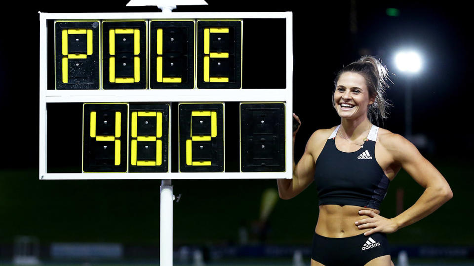 Nina Kennedy, pictured here posing next to her Australian Pole Vault record of 4.82m.