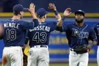 Tampa Bay Rays right fielder Manuel Margot celebrates with third baseman Mike Brosseau (43) and third baseman Joey Wendle (18) after the team defeated the Washington Nationals during a baseball game Tuesday, June 8, 2021, in St. Petersburg, Fla. (AP Photo/Chris O'Meara)