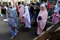 Muslim women walk after praying during Eid al-Fitr at a mosque inside city hall compound in Marawi City , Philippines June 25, 2017. REUTERS/Jorge Silva