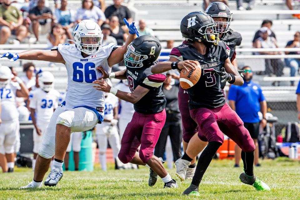 Hodgson Vo Tech Silver Eagles quarterback London Bright (3) looks for a pass with junior Mark Nelson (8) blocking a sack by Dover High School Senators sophomore Michael Stevenson (66) at Hodgson in Glasgow, Saturday, Sept. 10, 2022. Dover won 34-7.