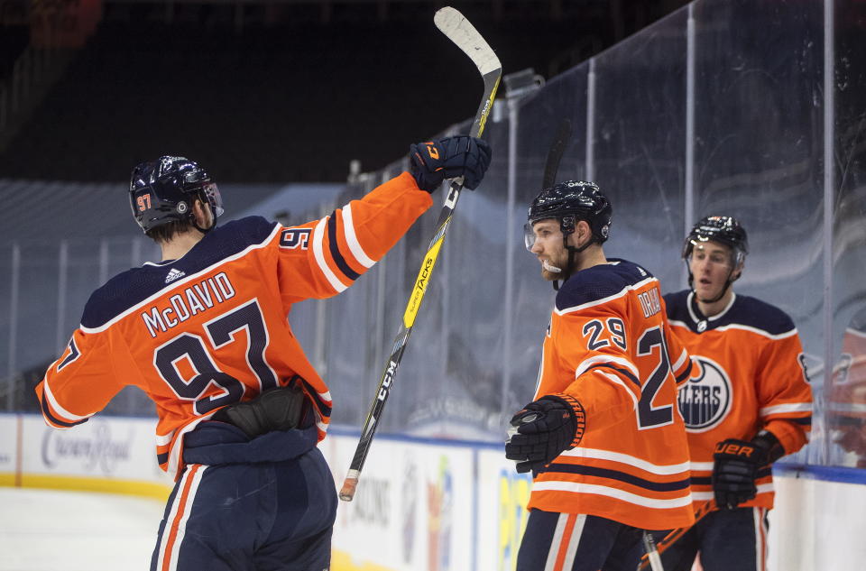 Edmonton Oilers' Connor McDavid (97), Leon Draisaitl (29) and Kyle Turris (8) celebrate a goal against the Ottawa Senators during second-period NHL hockey game action in Edmonton, Alberta, Monday, March 8, 2021. (Jason Franson/The Canadian Press via AP)