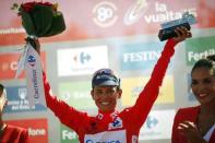 Orica GreenEdge rider Esteban Chaves of Colombia celebrates on the podium with the leader's red jersey after winning the 158.7 km (98.6 miles) 2nd stage of the Vuelta Tour of Spain cycling race from Alhaurin de la Torre to Caminito del Rey, in Ardales, southern Spain, August 23, 2015. REUTERS/Jon Nazca