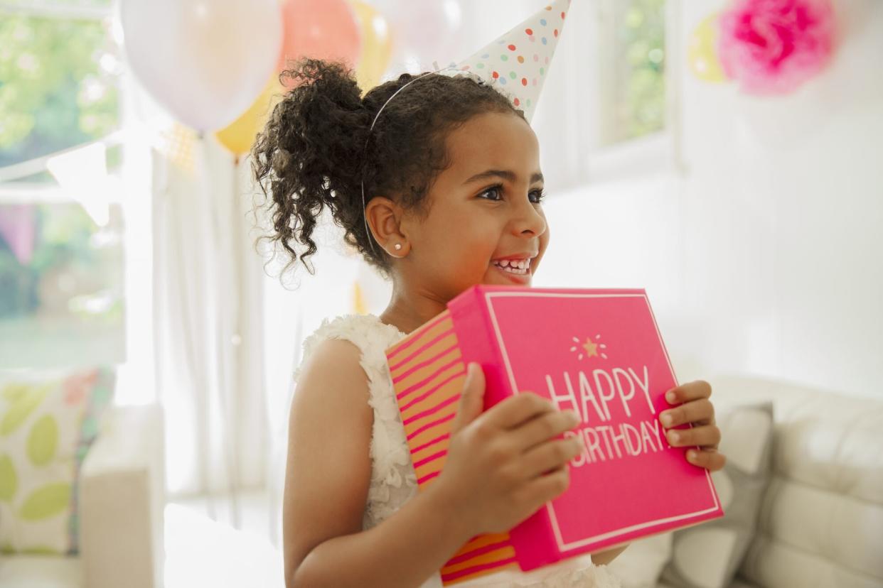 Child Holding Pink Birthday Gift Box