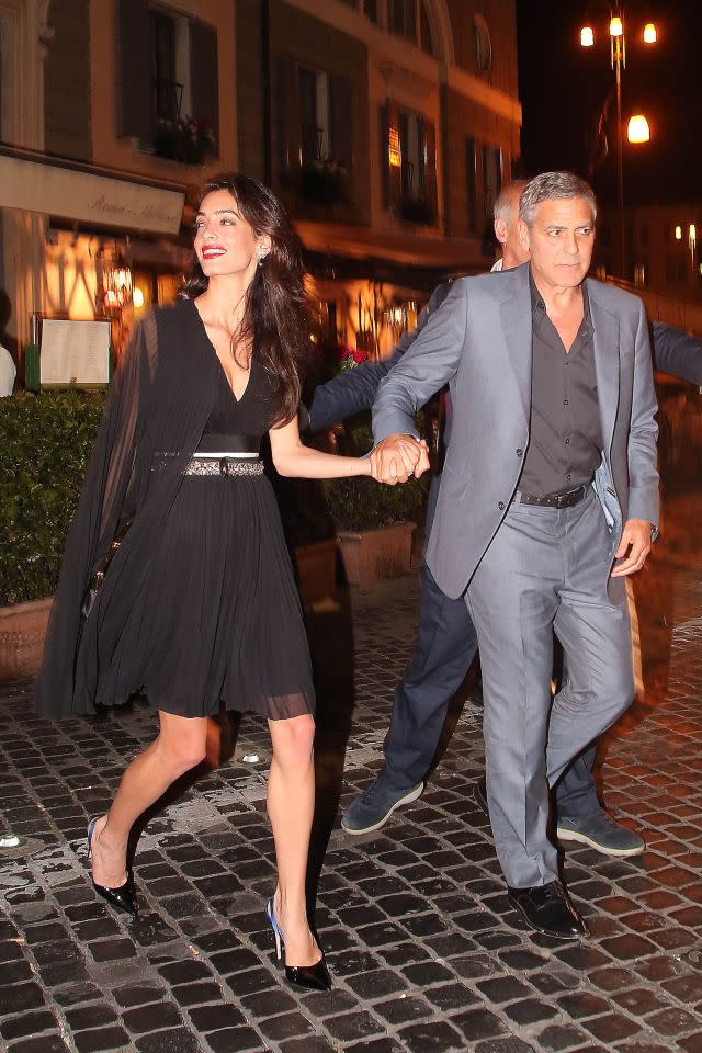 <p>Amal a opté pour une petite robe noire ample et une ceinture ornée lors d’une soirée romantique. (Photo par : Mertino / Splash News)</p>