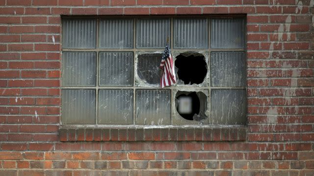 A U.S. flag is stuck in the broken window of a building on the grounds of the now-closed Bethlehem Steel mill in Bethlehem, Pennsylvania.